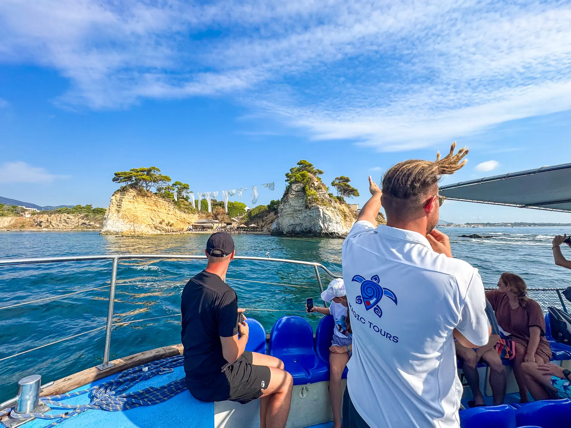 Widok na wyspę Cameo od strony morza – białe tkaniny, drewniany most i turkusowa woda Zakynthos.